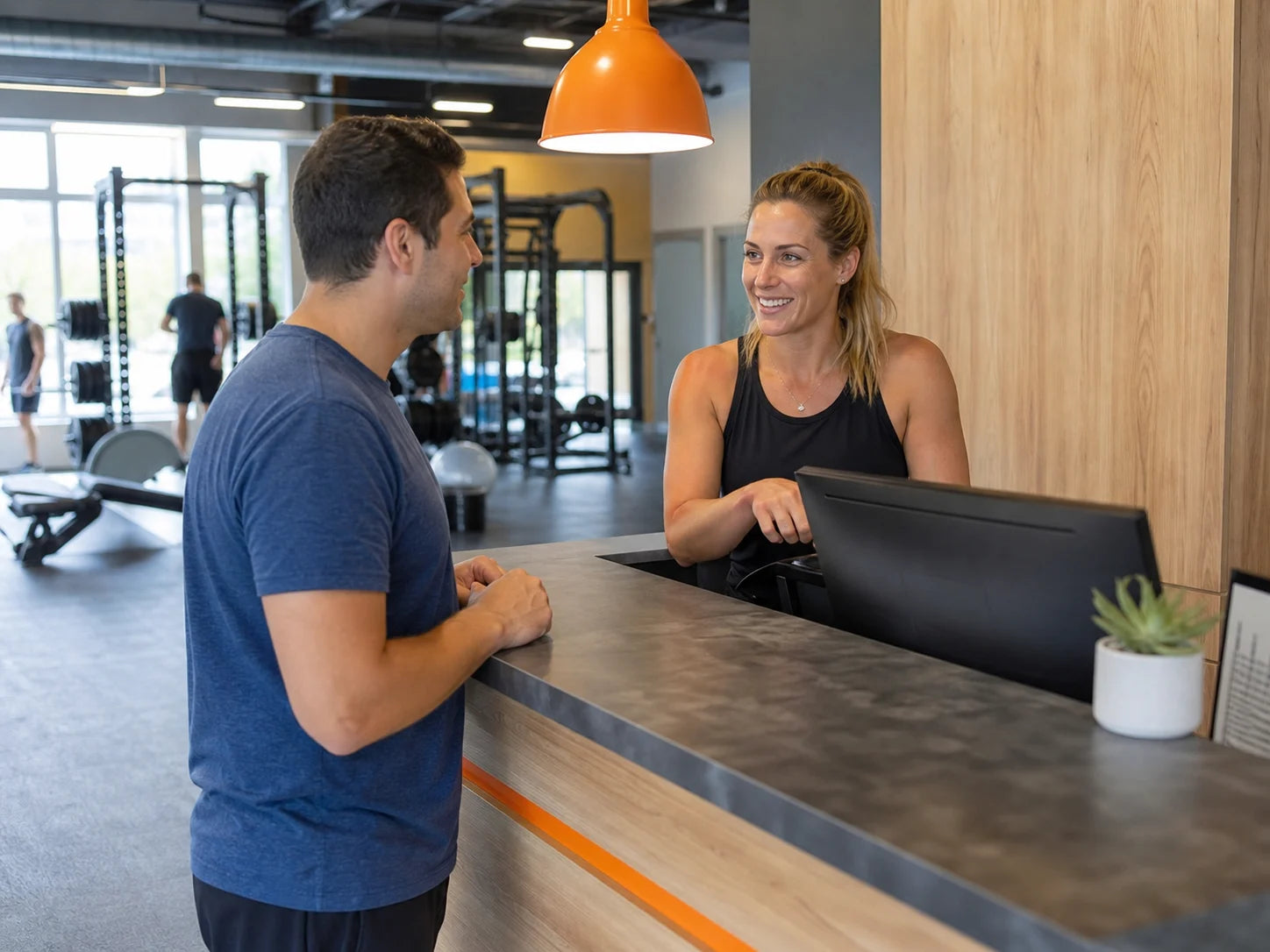 Fitness studio manager helping a prospective member