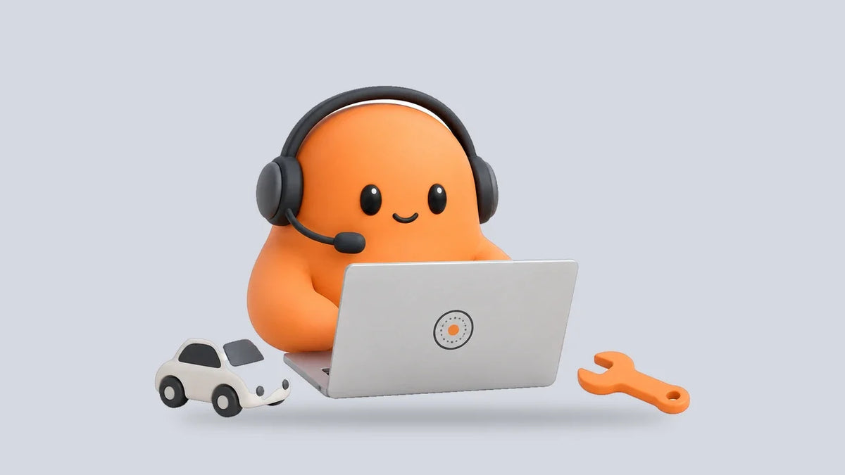 Mia at a laptop beside a small toy car and a wrench