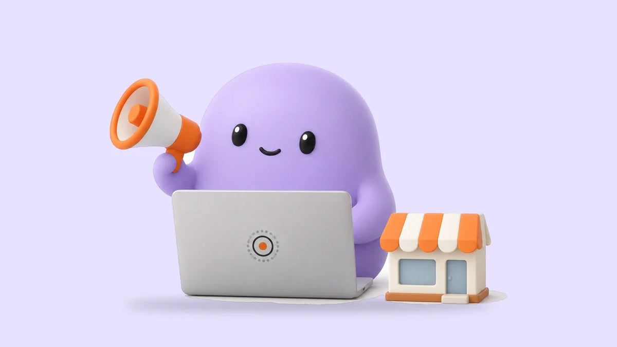 Reggie with a megaphone at a laptop beside a small storefront model