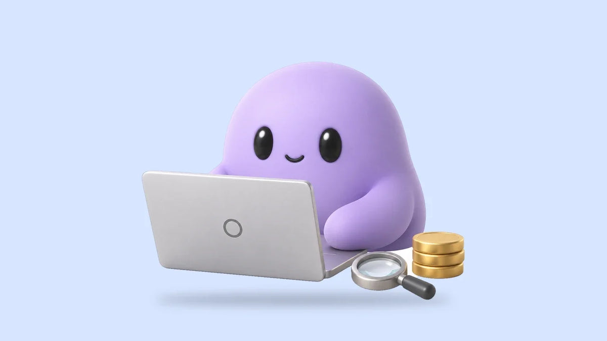 Reggie at a laptop beside a small magnifying glass and a stack of coins