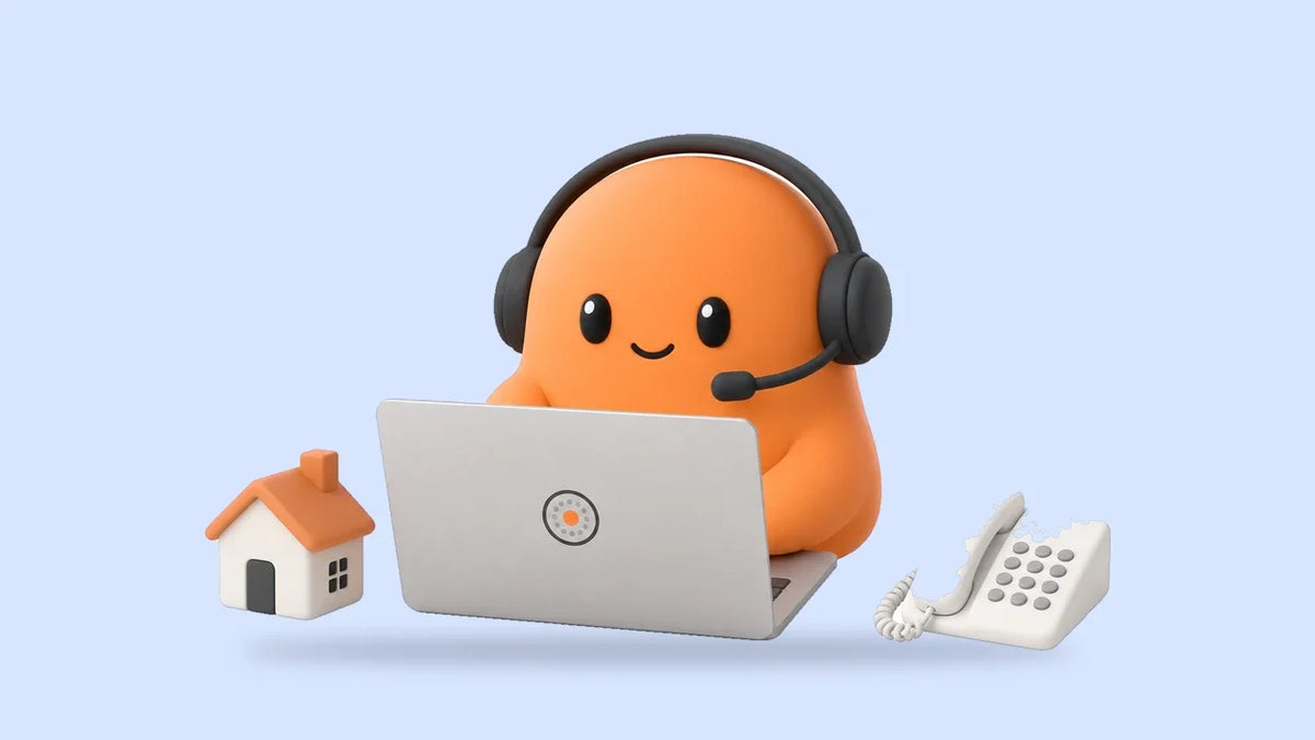 Mia in a headset at a laptop beside a small toy house and a desk phone