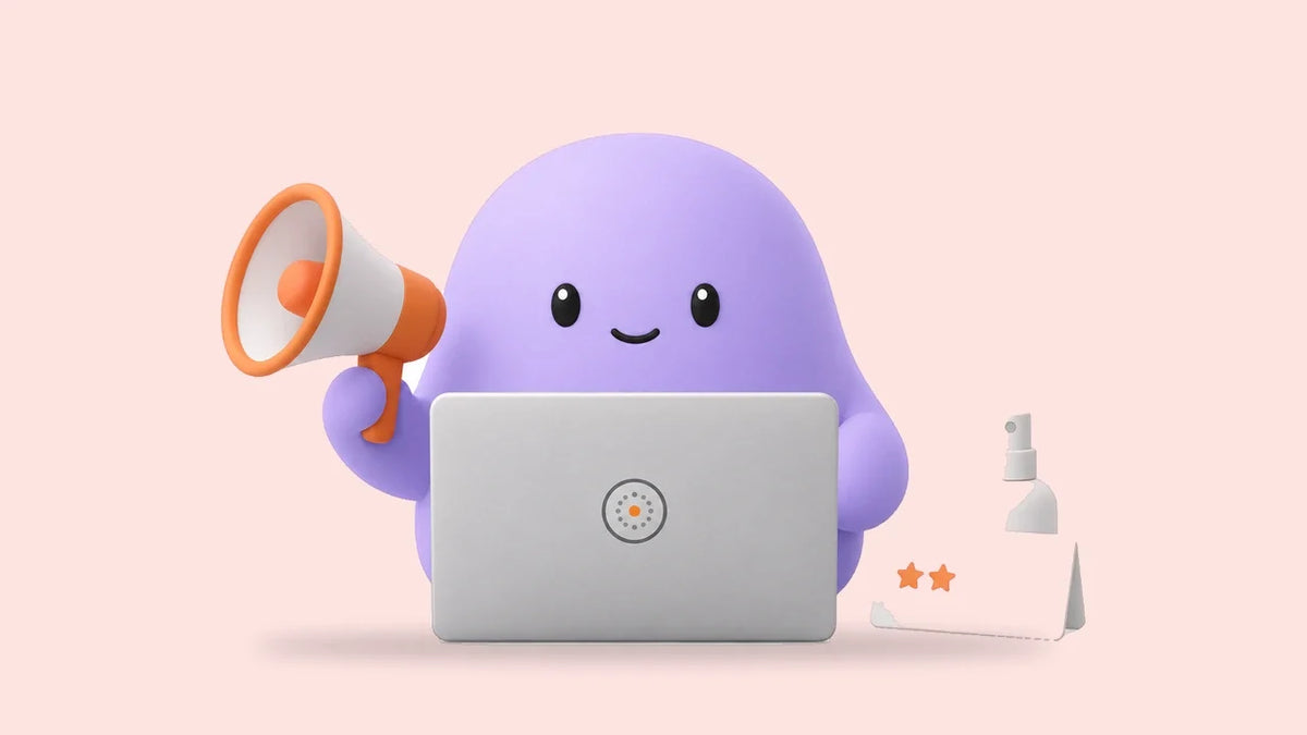Reggie at a laptop beside a small spray bottle and a card with two filled stars