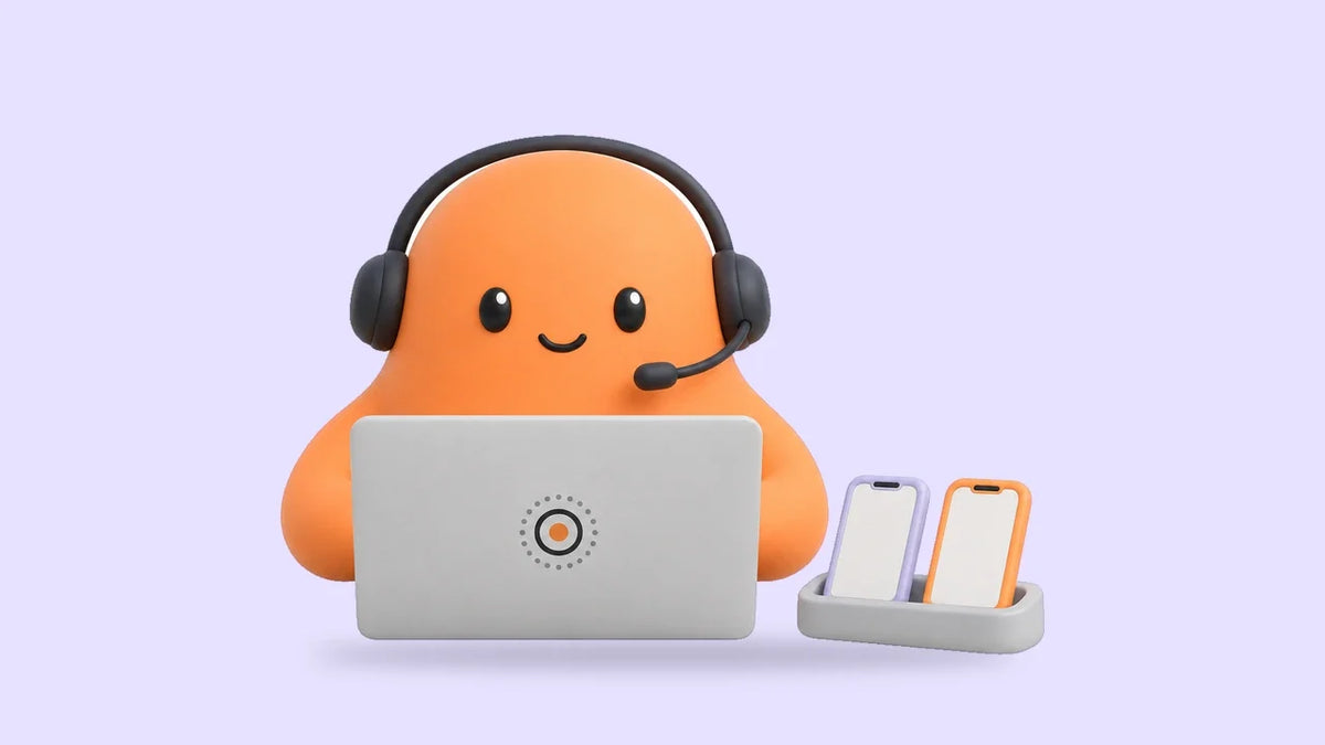 Mia in a headset at a laptop beside two small phone cards side by side on a tray