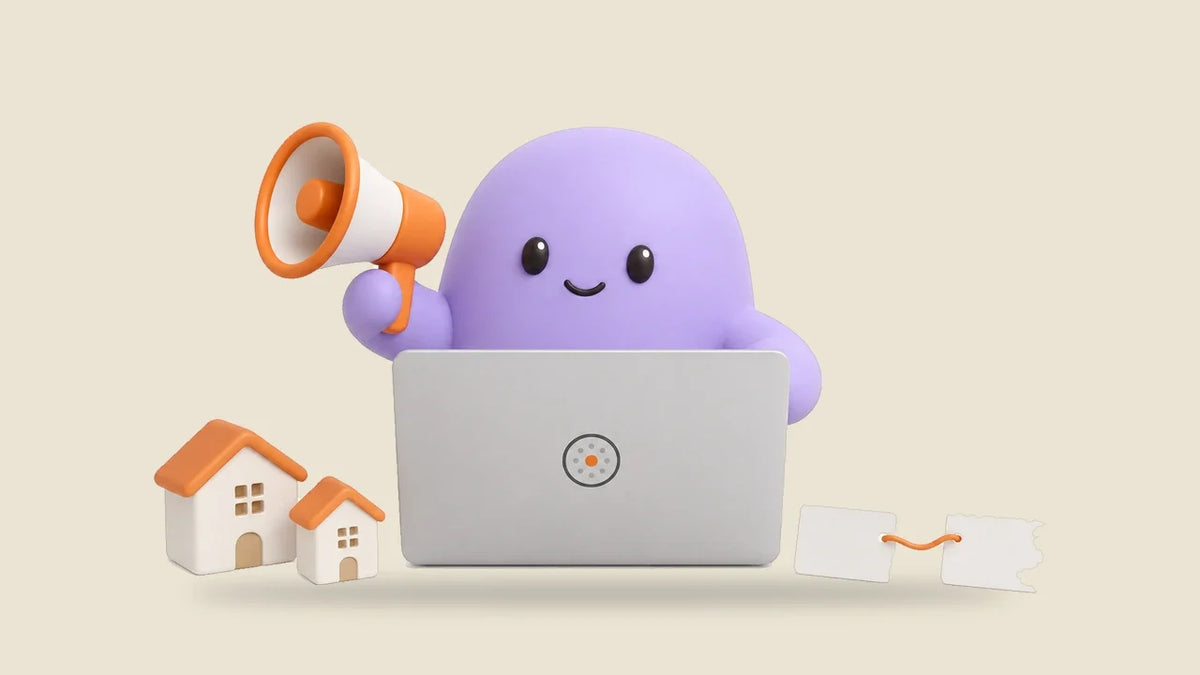 Reggie at a laptop beside two small toy houses and two linked cards