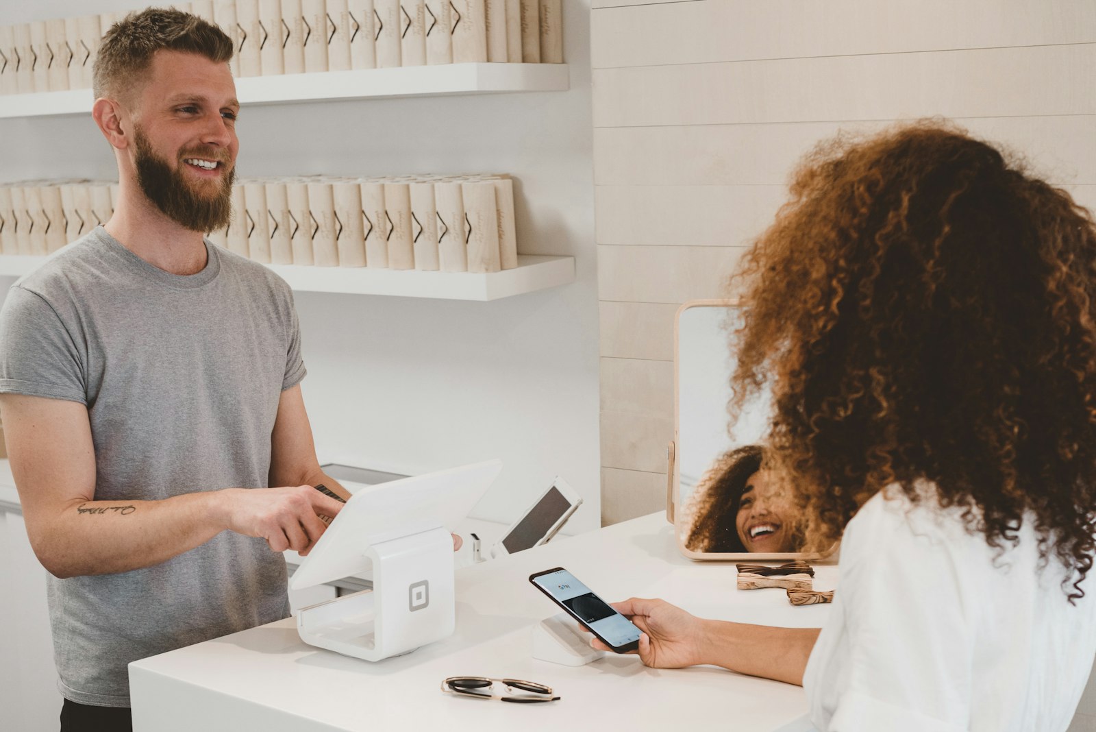 Customer tapping a card to pay at checkout