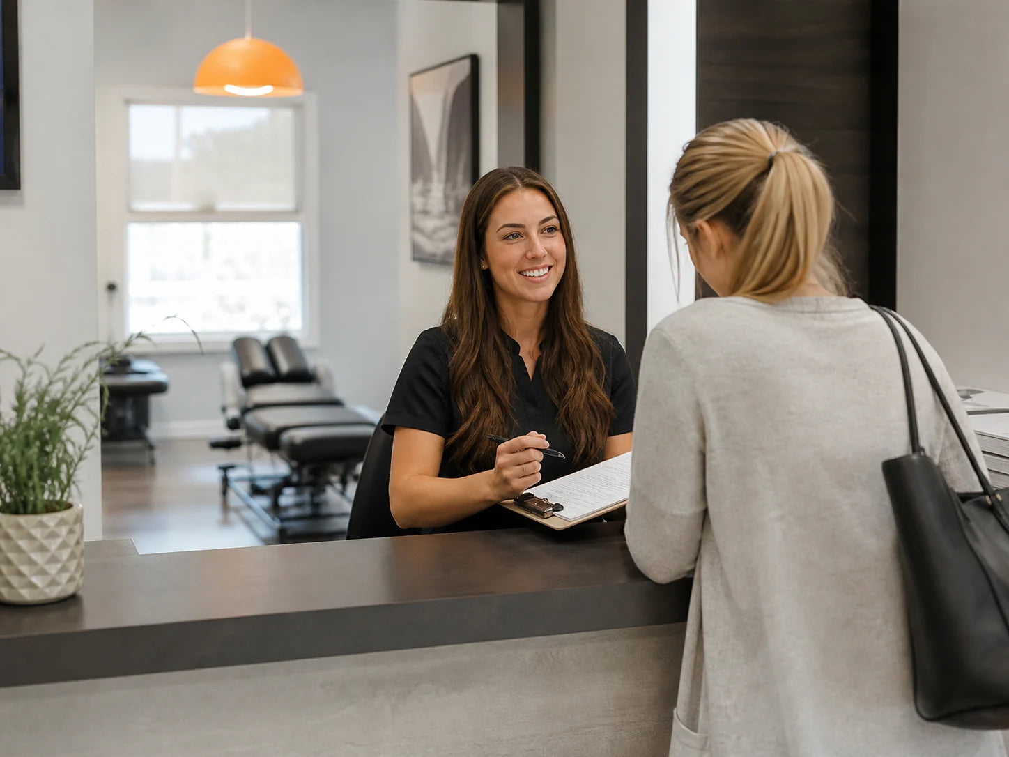 Chiropractic clinic coordinator welcoming a new patient