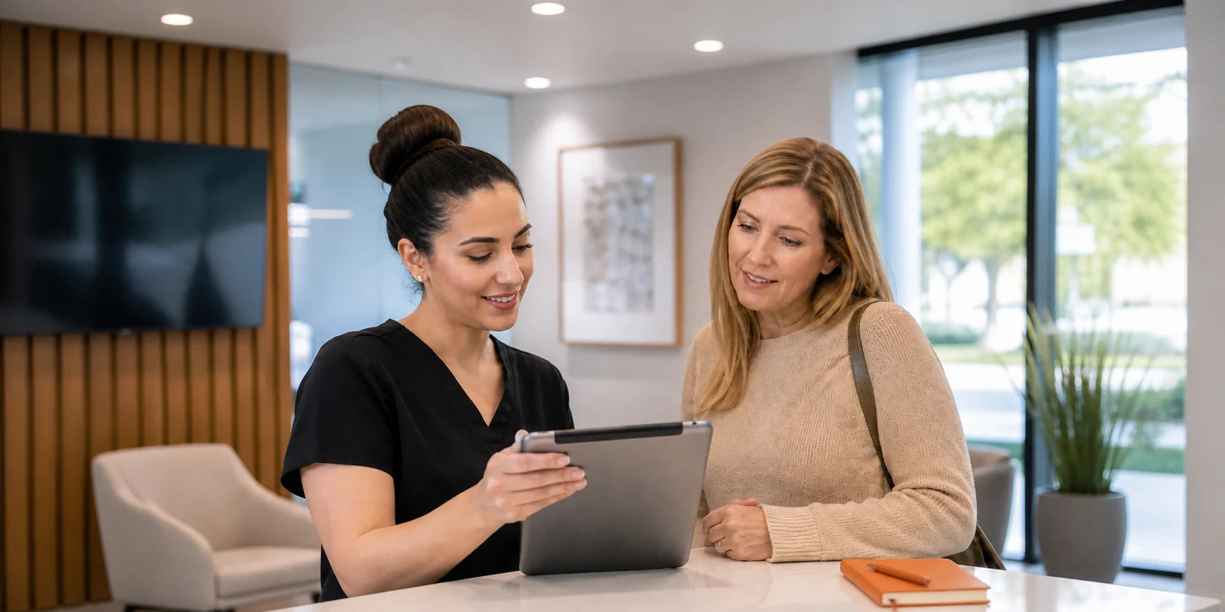 Dental front-desk coordinator helping a patient with an appointment