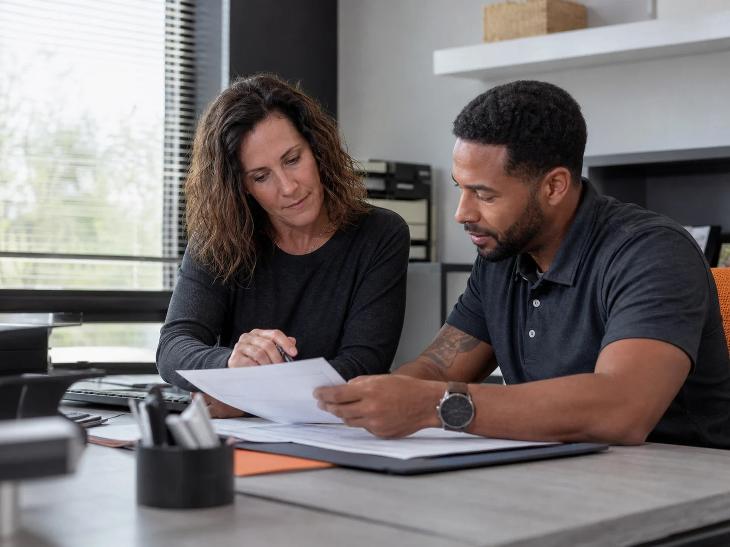 Property manager and maintenance coordinator reviewing a tenant request